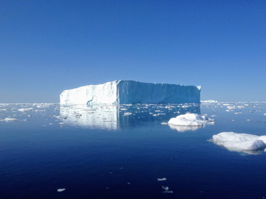 white and gray rock formation on blue sea under blue sky during daytime